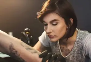 Tatuador profissional realizando tatuagem em estúdio